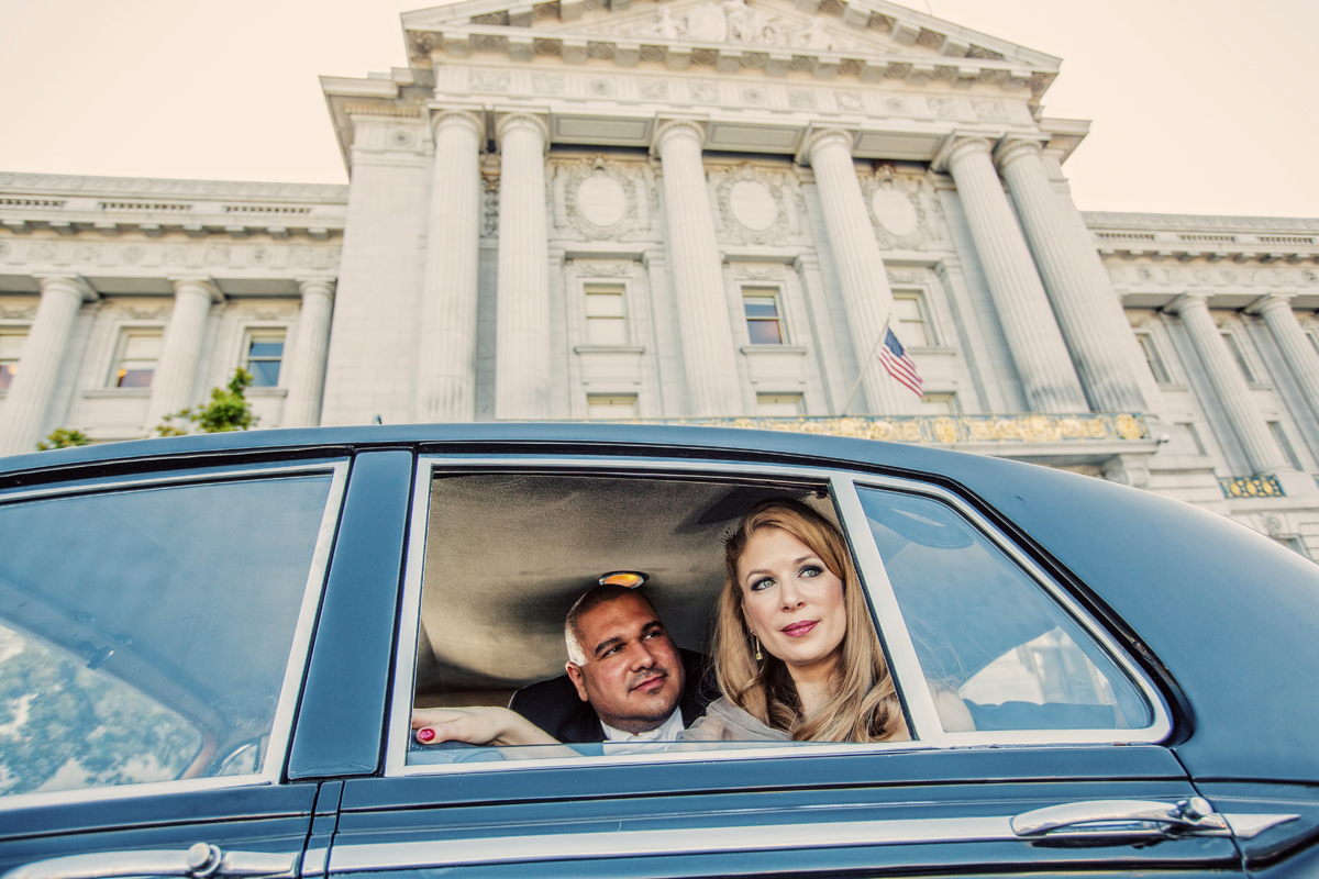 couple in rolls royce outside san francisco city hall